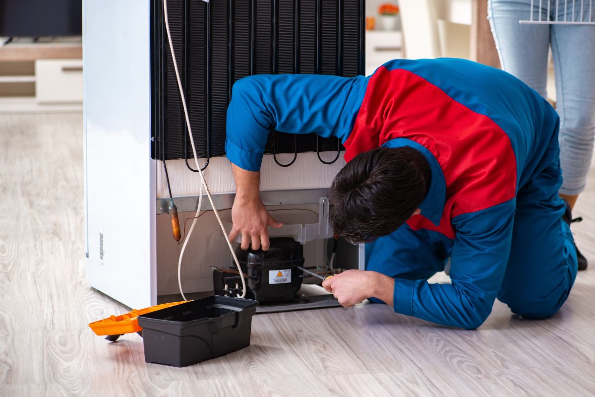 laki-laki memperbaiki kulkas